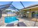 Sparkling swimming pool with screened-in patio and ample seating at 8205 Chico St, Port Charlotte, FL 33981