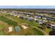 Aerial view of home with a pool on a golf course near a canal, in a sunny neighborhood at 84 Caddy Rd, Rotonda West, FL 33947