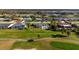 Aerial view of home with a pool on a golf course near a canal and sunny neighborhood at 84 Caddy Rd, Rotonda West, FL 33947