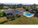 Aerial view of backyard with a swimming pool surrounded by a fence at 84 Caddy Rd, Rotonda West, FL 33947