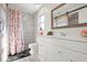 Bright bathroom featuring a modern vanity, marble-look shower, and a decorative floral shower curtain at 84 Caddy Rd, Rotonda West, FL 33947