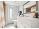 Bright bathroom featuring a modern vanity, shower with a tiled surround, and decorative elements at 84 Caddy Rd, Rotonda West, FL 33947