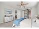 Bright bedroom with a ceiling fan, stylish barn door and soothing blue accents at 84 Caddy Rd, Rotonda West, FL 33947