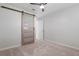 Bedroom featuring neutral carpet and closet with barn door at 84 Caddy Rd, Rotonda West, FL 33947