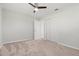 Bedroom with neutral carpet, closet with sliding doors, ceiling fan, and an adjacent doorway at 84 Caddy Rd, Rotonda West, FL 33947