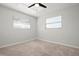 Bedroom with neutral carpet, two windows with blinds and a ceiling fan at 84 Caddy Rd, Rotonda West, FL 33947