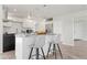 Kitchen island with modern pendant lighting and seating at 84 Caddy Rd, Rotonda West, FL 33947