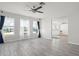 Spacious living room with ample natural light, neutral paint and gray wood-look tile floors at 84 Caddy Rd, Rotonda West, FL 33947