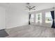 Sun-filled living room featuring gray wood-look tile floors and abundant natural light at 84 Caddy Rd, Rotonda West, FL 33947