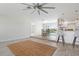 Open living space with wood floors, a ceiling fan, and lots of natural light at 84 Caddy Rd, Rotonda West, FL 33947