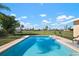 Backyard pool with a view of lush green surroundings, perfect for relaxation and entertainment at 84 Caddy Rd, Rotonda West, FL 33947