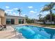 Beautiful backyard pool with ample lounge space and a clear view of the home's sliding glass doors at 84 Caddy Rd, Rotonda West, FL 33947