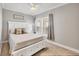 This bedroom features a ceiling fan, plush carpet, natural light through the window with blinds, and white bedding at 8403 Placida Rd # 401, Placida, FL 33946