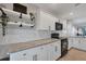 Bright kitchen featuring granite counters, white cabinets, and decorative shelving at 8403 Placida Rd # 401, Placida, FL 33946