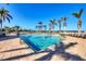 Community pool with clear blue water, several palm trees, and plenty of lounge chairs at 8403 Placida Rd # 401, Placida, FL 33946