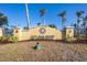 Entrance sign to Cape Haze Resort featuring lush landscaping with palm trees and clear skies at 8403 Placida Rd # 401, Placida, FL 33946