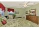 Comfortable bedroom with bright windows, floral bedding and wicker furniture at 8431 Nighthawk Dr, Englewood, FL 34224