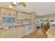 Bright kitchen with wood-look flooring, sink, and countertops with attached dining space at 8431 Nighthawk Dr, Englewood, FL 34224