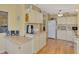 Well-lit kitchen with wood-look floors, ample counter space, and bright cabinetry at 8431 Nighthawk Dr, Englewood, FL 34224