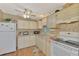 Functional kitchen with white appliances, warm-toned cabinetry, and ample counter space at 8431 Nighthawk Dr, Englewood, FL 34224