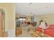 Cozy living room featuring bright sofas, a tropical rug, and access to the outdoor lanai at 8431 Nighthawk Dr, Englewood, FL 34224