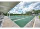 View of the community shuffleboard courts with ample seating, lighting, and covered viewing areas at 8431 Nighthawk Dr, Englewood, FL 34224