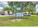 Lakeside Club community sign surrounded by lush landscaping and palm trees at 8431 Nighthawk Dr, Englewood, FL 34224