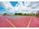 Well-maintained tennis court surrounded by lush greenery and community homes at 8431 Nighthawk Dr, Englewood, FL 34224