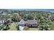 Beautiful aerial view of a waterfront home surrounded by lush trees and well-manicured landscaping at 955 Morrison Ave, Englewood, FL 34223