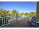 Enjoy this spacious balcony with tropical scenery and seating area at 955 Morrison Ave, Englewood, FL 34223