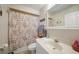 Bathroom with white sink and decorative ocean themed shower curtain at 955 Morrison Ave, Englewood, FL 34223