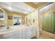 A well-lit bathroom featuring a double sink vanity and a walk-in shower at 955 Morrison Ave, Englewood, FL 34223