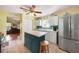 Bright kitchen with an island, stainless steel refrigerator, and ample cabinet space at 955 Morrison Ave, Englewood, FL 34223