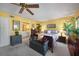 Comfortable main bedroom featuring a ceiling fan, warm paint, and an ensuite bathroom at 955 Morrison Ave, Englewood, FL 34223