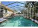 A screened-in pool and spa are steps from the deck, perfect for entertaining and enjoying the beautiful Florida weather at 955 Morrison Ave, Englewood, FL 34223