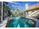 A screened-in pool with tile accents provides a relaxing place to cool off and lounge by the pool at 955 Morrison Ave, Englewood, FL 34223