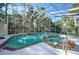 Enclosed, in-ground pool and spa with an attached deck perfect for entertaining or relaxing poolside at 955 Morrison Ave, Englewood, FL 34223