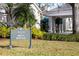 The Club at Boca Royale sign with a view of the clubhouse entrance and landscaping at 10 Bermuda Cir # 57, Englewood, FL 34223