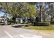 Entrance to a community with a guard house, gates, and mature trees along the driveway at 10 Bermuda Cir # 57, Englewood, FL 34223