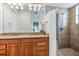 Bathroom featuring a tiled shower with glass door and a wood vanity with double sinks at 10301 Coral Landings Ln # 6, Placida, FL 33946