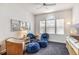 Bright sitting room with blue upholstered chairs, wicker chair and media center at 10301 Coral Landings Ln # 6, Placida, FL 33946