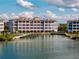 Luxury waterfront condominium with private docks and stunning water views under a blue sky with puffy clouds at 11120 Hacienda Del Mar Blvd # F-301, Placida, FL 33946