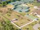 Aerial shot of community amenities, showcasing tennis courts, bocce ball, dog park, and clubhouse at 13241 Scrub Jay Ct, Port Charlotte, FL 33953
