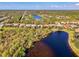Aerial view of homes, lush landscape, and lakes in the community at 13241 Scrub Jay Ct, Port Charlotte, FL 33953