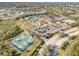 An aerial view showcasing the community's tennis courts, lawn bowling, clubhouse, pool, and parking at 13241 Scrub Jay Ct, Port Charlotte, FL 33953