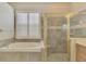 A bathroom with a soaking tub, shower, and tile surround at 13241 Scrub Jay Ct, Port Charlotte, FL 33953