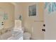 Light and airy half bath features decorative mirror and fixtures at 13241 Scrub Jay Ct, Port Charlotte, FL 33953