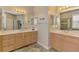 Bathroom boasts dual vanities with ample cabinet space, a shower, and neutral tile flooring at 13241 Scrub Jay Ct, Port Charlotte, FL 33953
