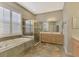 The primary bathroom features a tiled floor, a soaking tub, and a separate glass shower at 13241 Scrub Jay Ct, Port Charlotte, FL 33953