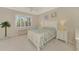 Bright bedroom with a large window, white furniture, and floral bedding offers a peaceful retreat at 13241 Scrub Jay Ct, Port Charlotte, FL 33953